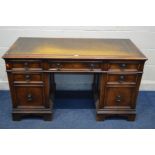 A REPRODUCTION OAK PEDESTAL DESK, tan leather and gilt tooled inlay top, and seven various