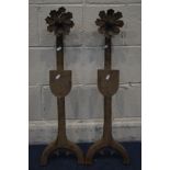 A PAIR OF VINTAGE CAST IRON FIRE DOGS, with flower heads above a shield, height 87cm (front of