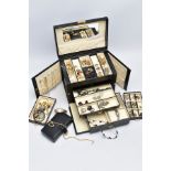 A LARGE LEATHER JEWELLERY BOX containing a large amount of silver and mostly costume jewellery,