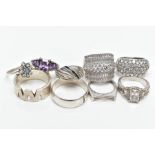 NINE WHITE METAL RINGS, to include a silver zig zag pattern wide band hallmarked silver