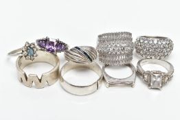 NINE WHITE METAL RINGS, to include a silver zig zag pattern wide band hallmarked silver