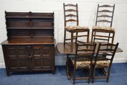 A DARK ERCOL DINING SUITE, comprising a refectory table, length 153cm x depth 78cm x height 73cm,