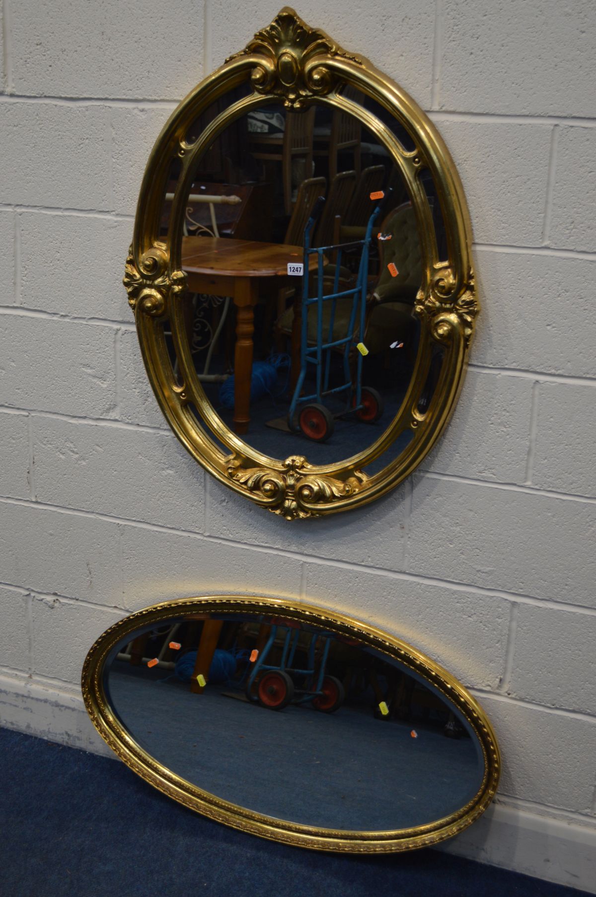 A MODERN GILT FRAMED OVAL WALL MIRROR, 74cm x 99cm along with another oval wall mirror (2)