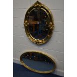 A MODERN GILT FRAMED OVAL WALL MIRROR, 74cm x 99cm along with another oval wall mirror (2)