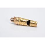 A GOLD PLATED MINIATURE WHISTLE CHARM, decorated with an engraved floral design fitted with a jump