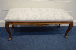 A LONG REPRODUCTION BEECH FOOTSTOOL on claw feet, length 115cm (this stool does not comply with