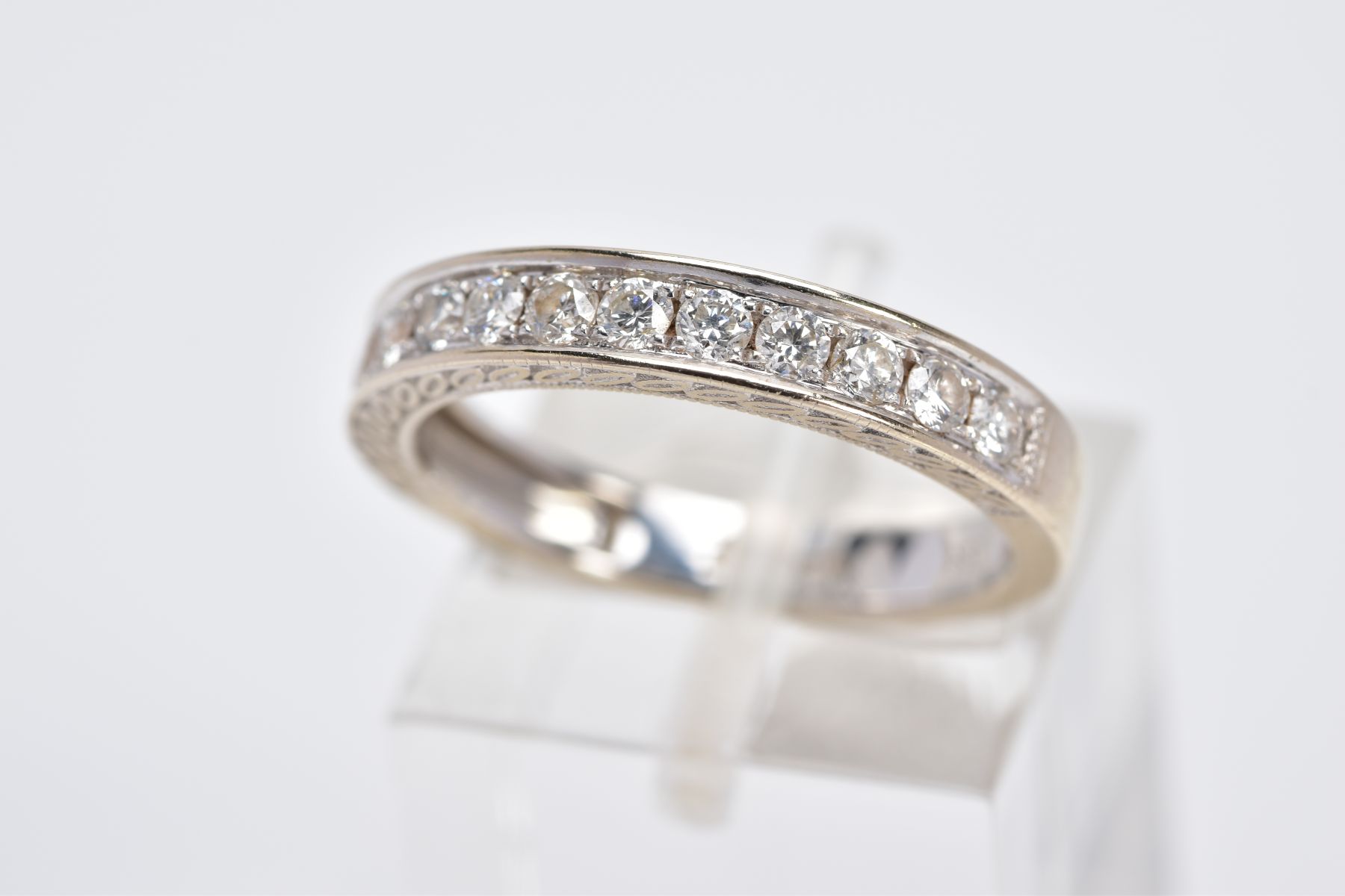 AN 18CT WHITE GOLD DIAMOND HALF ETERNITY RING, designed with a row of round brilliant cut