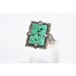 A MARCASITE RING, of rectangular form set with a carved floral green and white central panel