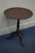 AN EARLY 20TH CENTURY MAHOGANY DISH TOP TRIPOD TABLE, with a wavy edge, diameter 52cm x height