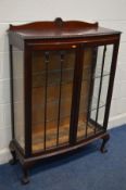 AN EARLY 20TH CENTURY MAHOGANY ASTRAGAL GLAZED DOUBLE DOOR DISPLAY CABINET, on ball and claw feet,