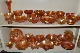 A COLLECTION OF ORANGE CARNIVAL GLASS, including bowls, vases, platters and jugs, approximately