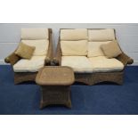 A WICKER THREE PIECE LOUNGE SUITE, with cream cushions, comprising a two seater settee, armchair and
