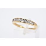 AN 18CT GOLD DIAMOND HALF HOOP RING, set with a row of channel set round brilliant cut diamonds,