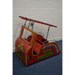 A VINTAGE CHILDS FAIRGROUND CAROSEL RIDE, in the form of a wooden fire engine, complete with