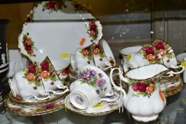 A ROYAL ALBERT OLD COUNTRY ROSES TWENTY THREE PIECE TEA SET, comprising six cups, six saucers, seven