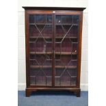 AN EARLY 20TH CENTURY MAHOGANY ASTRAGAL GLAZED DOUBLE DOOR BOOKCASE, with four adjustable wooden