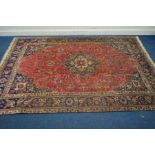 A 20TH CENTURY WOOLLEN SAROUK CARPET SQUARE, red field with a blue border, 304cm x 208cm (some low