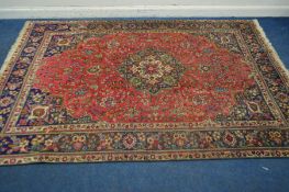 A 20TH CENTURY WOOLLEN SAROUK CARPET SQUARE, red field with a blue border, 304cm x 208cm (some low