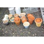 A QUANTITY OF TERRACOTA AND GLAZED PLANT POTS and a composite figure of a Bichon Freize