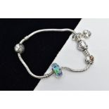 A PANDORA CHARM BRACELET, the snake chain bracelet fitted with four charms such as a cubic