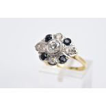 A YELLOW METAL DIAMOND AND SAPPHIRE RING, designed with a central early brilliant cut diamond in a