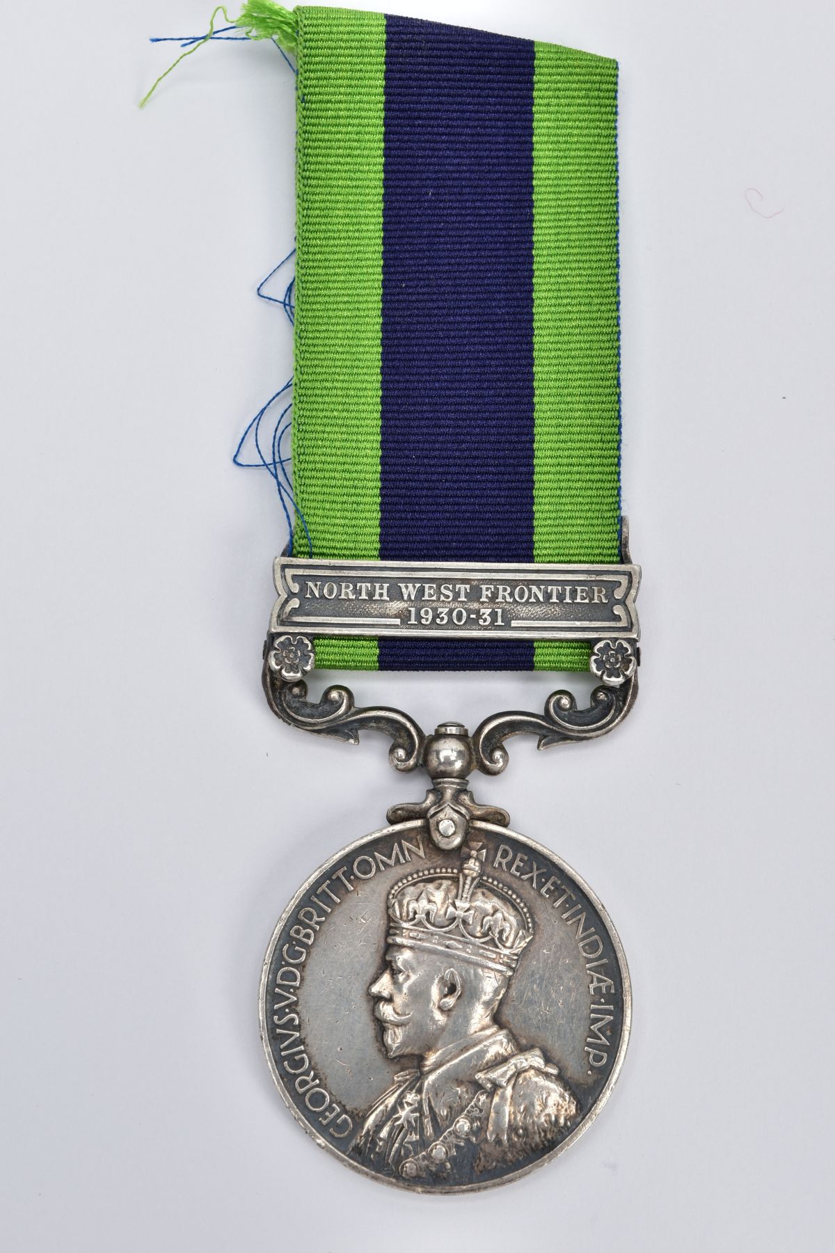 A GEORGE V MEDAL WITH RIBBON, round medal of 'North West Frontier 1930-31 India' awarded to '4384811