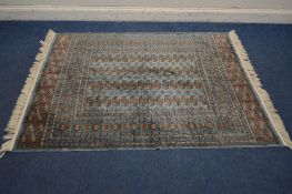 A TEKKE SPUN RAYON RUG, with pale blue field and a multi strap border, Bombay label to underside,