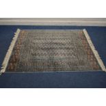 A TEKKE SPUN RAYON RUG, with pale blue field and a multi strap border, Bombay label to underside,
