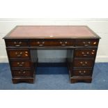 A MAHOGANY PEDESTAL DESK with a burgundy leather and gilt tooled inlay top, above nine drawers,