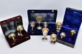 THREE CASED SETS OF WINE AND BRANDY METAL GOBLETS, assorted design each engraved in a foliate and