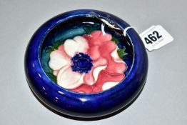 A MOORCROFT POTTERY SHALLOW SHOULDERED BOWL, dark blue ground with pink/red anemone, impressed mark,