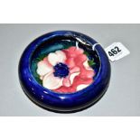 A MOORCROFT POTTERY SHALLOW SHOULDERED BOWL, dark blue ground with pink/red anemone, impressed mark,