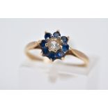 A 9CT GOLD CLUSTER RING, the raised cluster designed with a central circular cut colourless stone