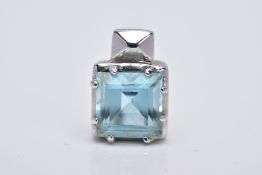 A WHITE METAL BLUE TOPAZ PENDANT, of a square shape, designed with a claw set square cut blue