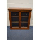 A VICTORIAN WALNUT GLAZED TWO DOOR BOOKCASE, with two adjustable shelves, width 107cm x depth 35cm x