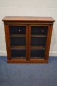 A VICTORIAN WALNUT GLAZED TWO DOOR BOOKCASE, with two adjustable shelves, width 107cm x depth 35cm x