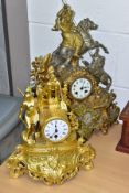 TWO LATE 19TH CENTURY GILT METAL FIGURAL MANTEL CLOCKS, the taller clock with a Middle Eastern