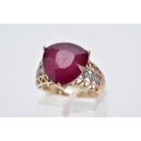 A 9CT GOLD RUBY AND DIAMOND RING, designed with a triangular cut ruby approximate dimensions 13.