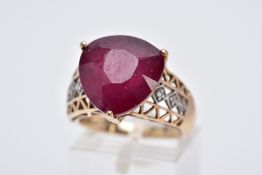 A 9CT GOLD RUBY AND DIAMOND RING, designed with a triangular cut ruby approximate dimensions 13.