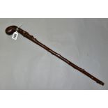 A LATE 19TH/EARLY 20TH CENTURY CLUB HANDLED SHORT THORN STICK, carved below the handle with a man