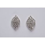 A PAIR OF WHITE METAL DIAMOND EARRINGS, each of a marquise shape set with single cut diamonds in the