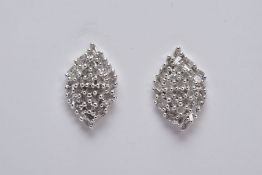 A PAIR OF WHITE METAL DIAMOND EARRINGS, each of a marquise shape set with single cut diamonds in the