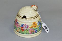 A CLARICE CLIFF FOR NEWPORT POTTERY HONEYPOT AND COVER, with painted bee finial, the body