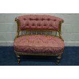 A 19TH CENTURY LOUIS XVI STYLE GILTWOOD TWO SEATER SOFA, upholstered in buttoned pink upholstery,