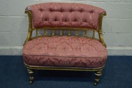 A 19TH CENTURY LOUIS XVI STYLE GILTWOOD TWO SEATER SOFA, upholstered in buttoned pink upholstery,