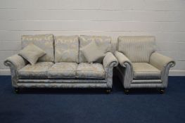 AN UPHOLSTERED TWO PIECE LOUNGE SUITE, on turned front legs, comprising a gold floral upholstered