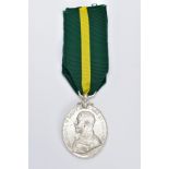 A GEORGE V MEDAL WITH RIBBON, an oval medal of 'Territorial Force Efficiency Medal' awarded to