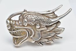 A WHITE METAL ORIENTAL BELT BUCKLE, in the form of a dragon head oriental stamps to the reverse,