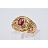 A TIFFANY & CO COLLEGE RING, designed with a central oval cut Garnet within a collet mount inscribed