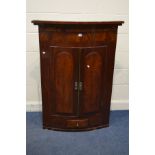 A GEORGIAN MAHOGANY FLAME MAHOGANY BARRELL TWO DOOR HANGING CORNER CUPBOARD (SD and losses)(blue